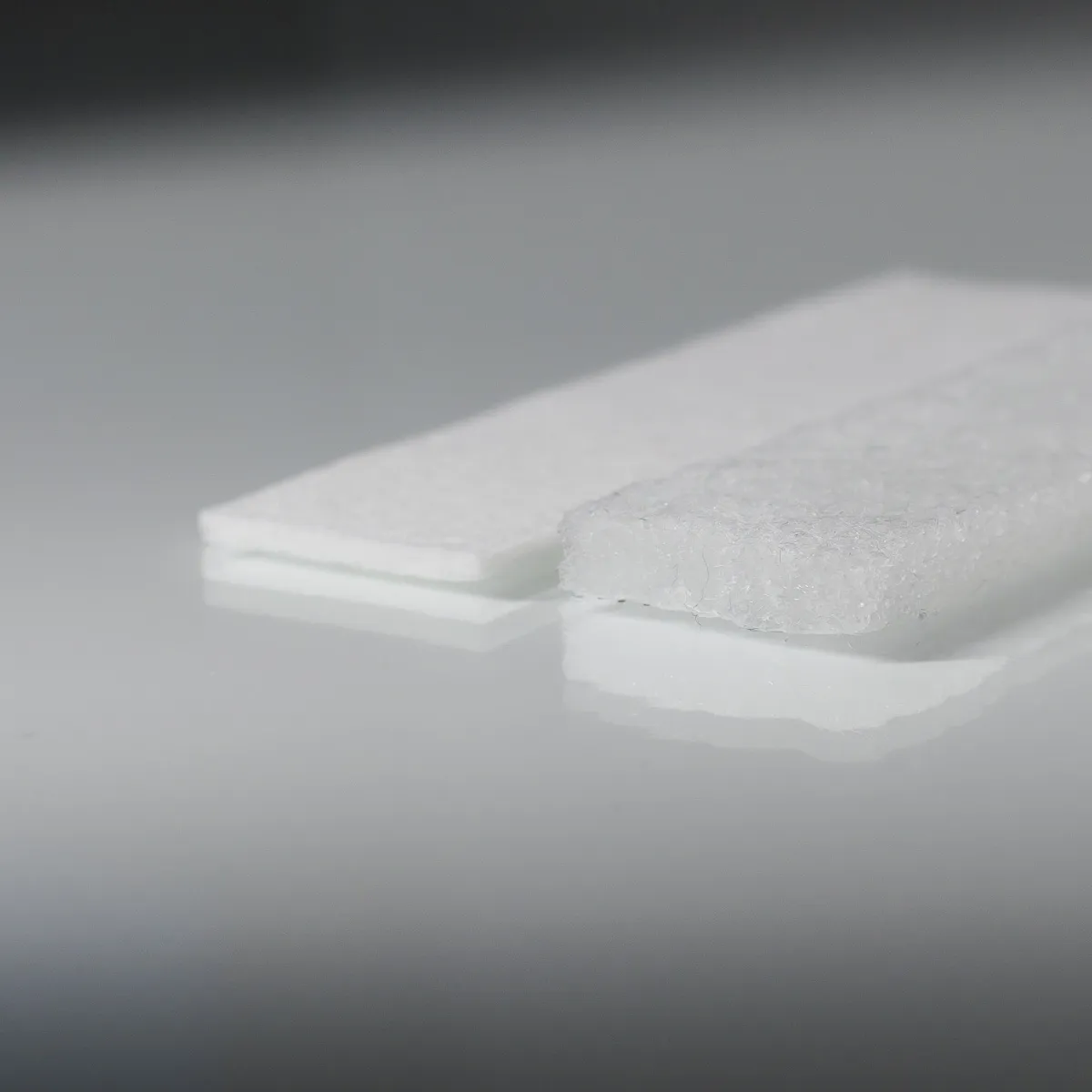 Type 2809 200gsm Superabsorbent Airlaid Fabric with a laminate nonwoven bottom layer on a grey background